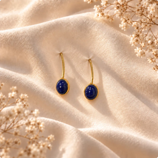 Slim gold plated earrings with a deep blue jasper set in an oval bezel. Ankkshi's Aakar collection.