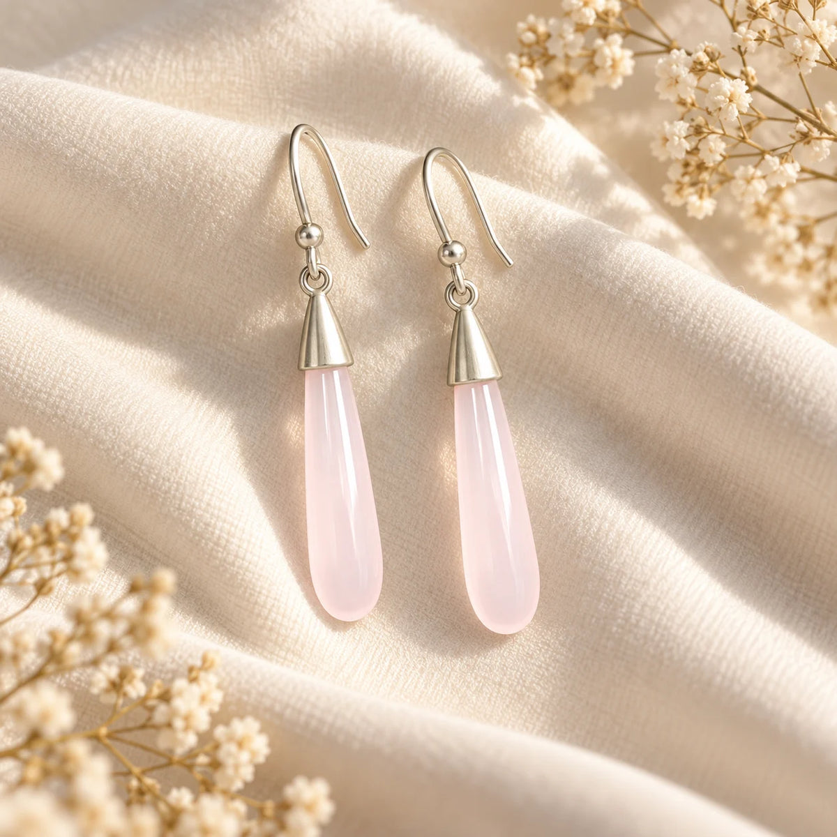 Silver plated hook earrings with a long polished pink stone drop. Ankkshi's Aakar collection.