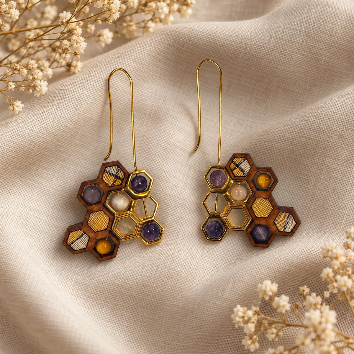 Hexagon honeycomb drop earrings with honey jade, amethyst and mother-of-pearl in gold plated frames. Ankkshi's Aakar collection.