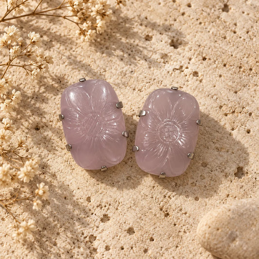 Carved rose quartz stud earrings with a soft pink-lilac tone and a delicate floral motif. Ankkshi's Aakar collection.