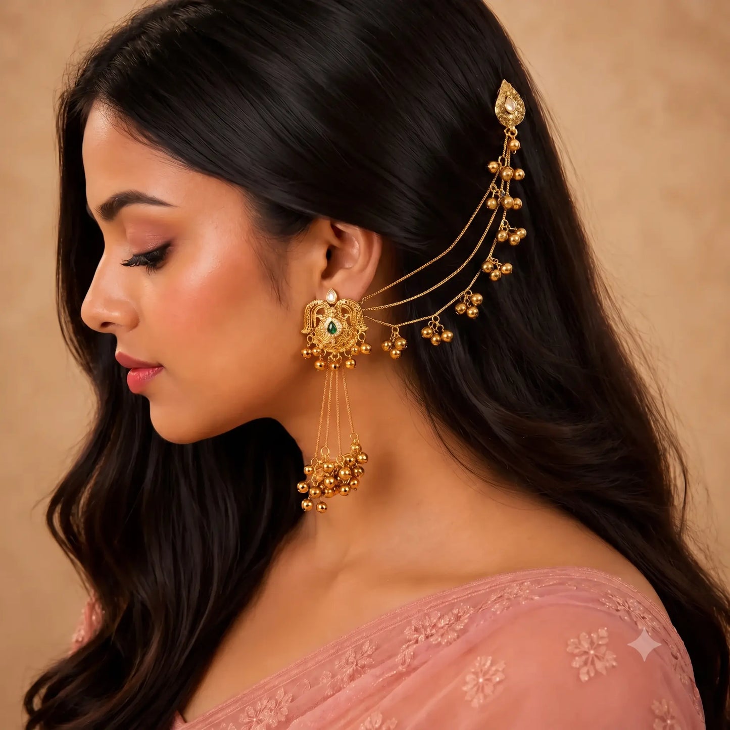 Indian woman wearing Ankkshi Kashmiri Gulmohar emerald ear cuff with kundan stones, emerald green accents, pearl drops and antique gold finish.