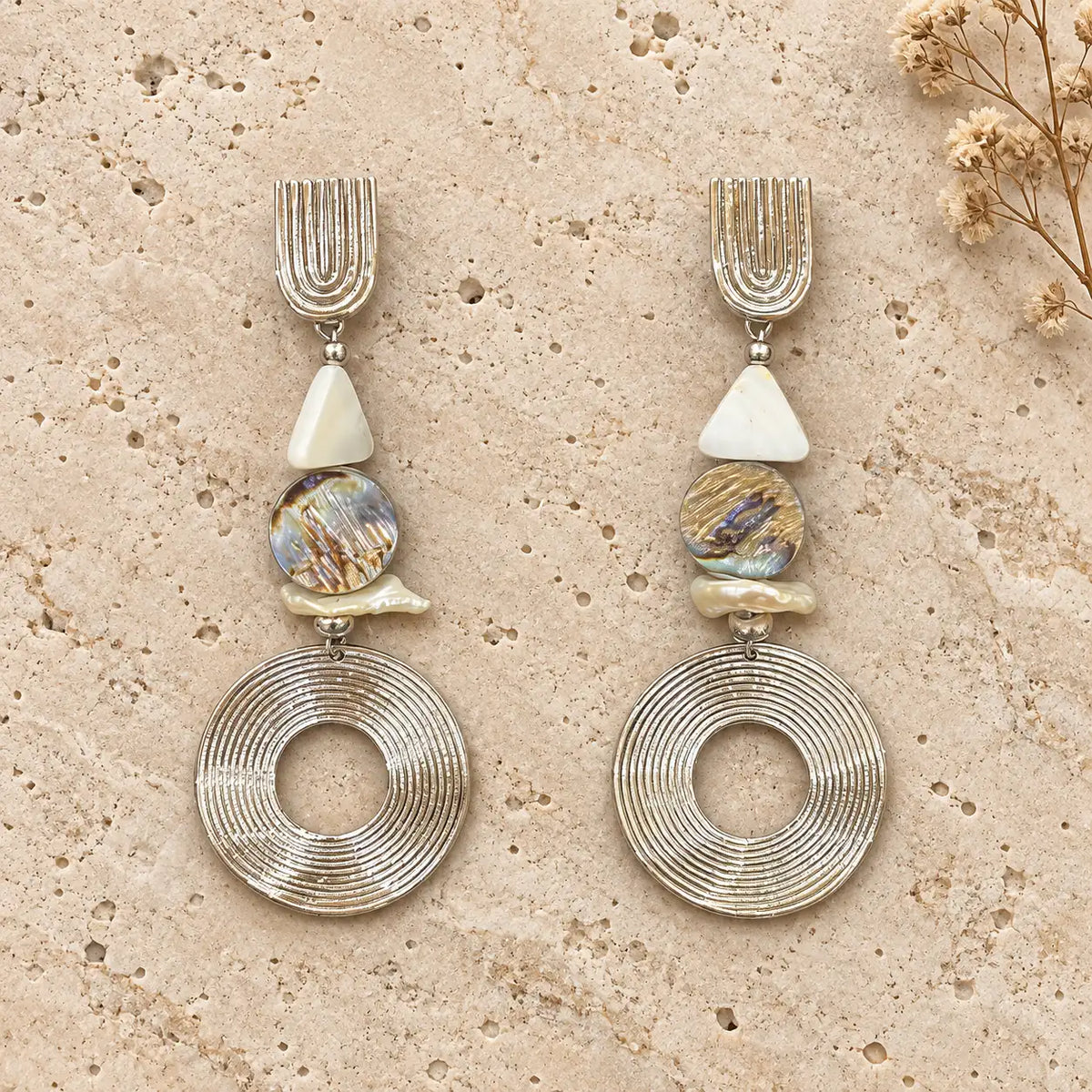 Sculptural white gold plated earrings with abalone shell, mother of pearl & pearl chip detailing. Ankkshi's Aakar collection.