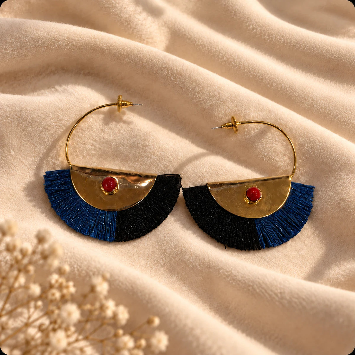 Bold gold plated fan hoops with red jasper centre stone and navy-black silk tassel fringe. Ankkshi's Aakar collection.