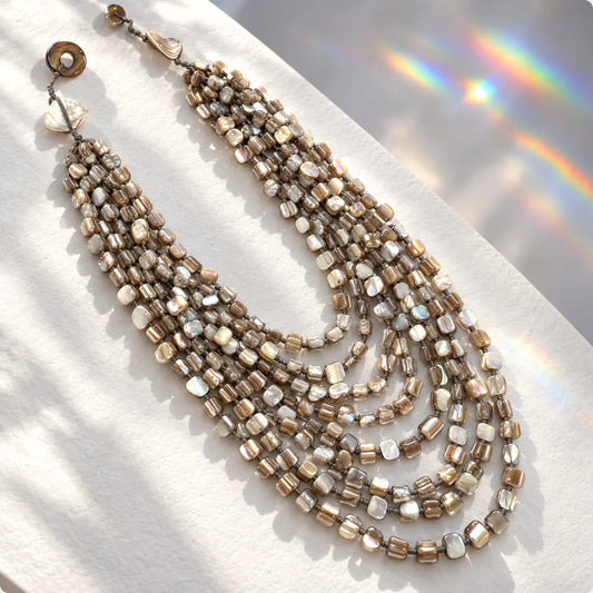 Multi-strand cascading necklace in iridescent genuine shell beads. Bold, handcrafted design from Ankkshi's Aakar collection.