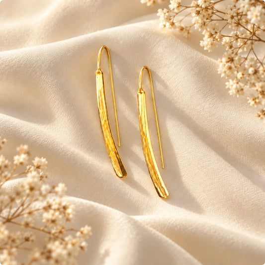 Slim hammered gold plated threader earrings with a softly curved bar and a light-catching finish. Ankkshi's Aakar collection.