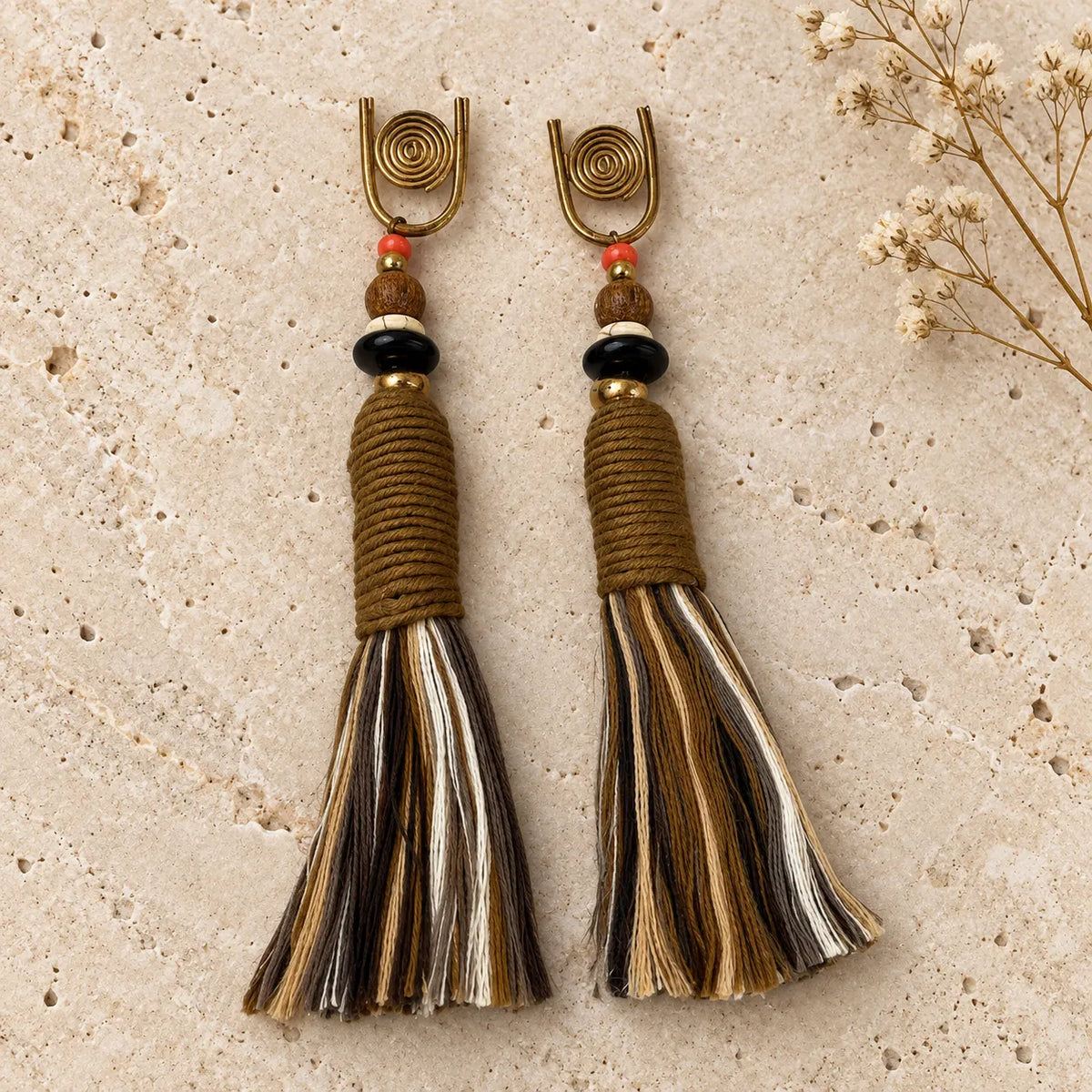 Multi-toned cotton tassel earrings with wood and coral bead accents. Handcrafted, earthy design from Ankkshi's Aakar collection.