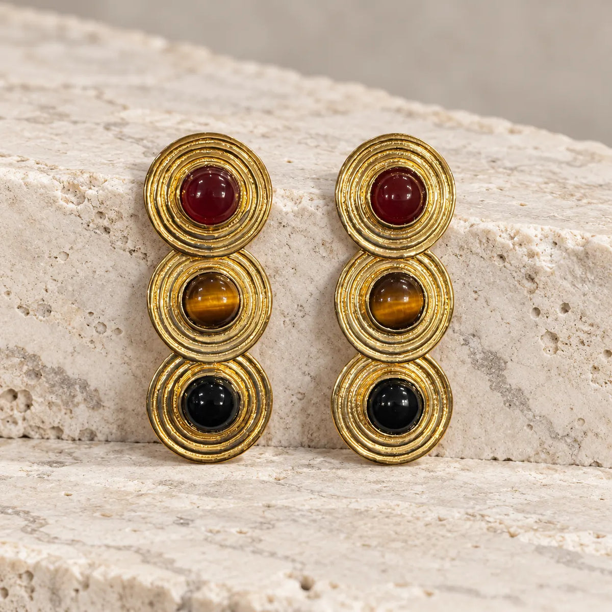 Bold stacked stud earrings in 18k gold plated metal with carnelian, tiger's eye & black agate. Ankkshi's Aakar collection.