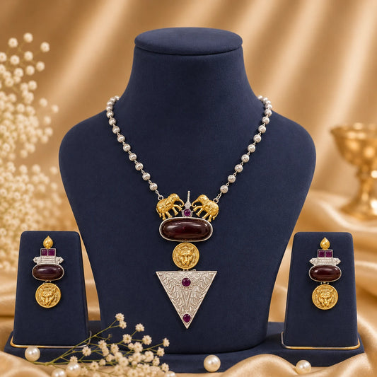 Simhika Oxidised Heritage Necklace Set in Ruby Wine featuring lion medallions, elephant motifs, oxidised silver detailing and matching earrings